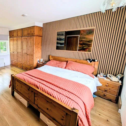 Bedroom with a natural wood panel feature wall